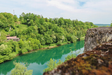 Fototapeta na wymiar Fascinating Korana river coloured in green as the dense forest in its surroundings, beautiful tourist destination near the city of Karlovac, Croatia