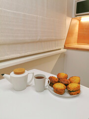 Romantic dinner in a white kitchen by candlelight.