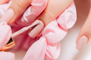 Manicure process. Manicurist paints fingernails. Nail polish.