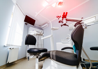 Dentistry, medicine, medical equipment and stomatology concept - interior of new modern dental clinic office with chair