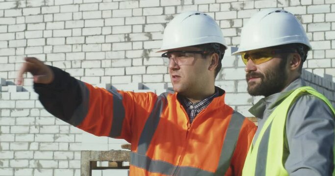 Contactor showing construction site to colleague
