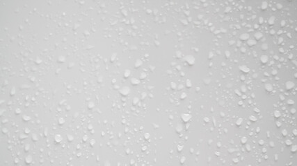 Clear water drops on glass surface