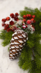 Christmas toys close-up, blurred bokeh background. Christmas background for a postcard. Spruce branches, cones, Christmas balls. Box with a gift and a red bow.