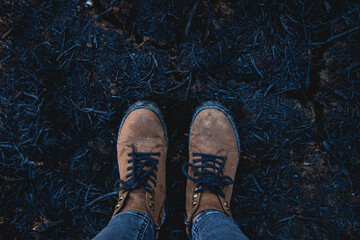 boots over burnt field
