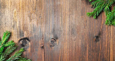 Branches of a Christmas tree on an aged wooden background. Photo with place for text for Christmas greetings. banner blank layout.