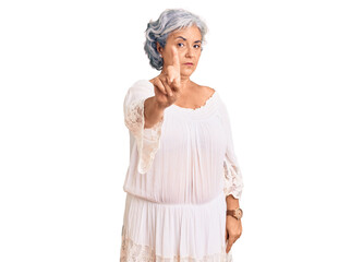 Senior woman with gray hair wearing bohemian style pointing with finger up and angry expression, showing no gesture