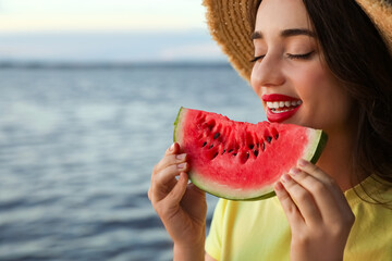 Beautiful young woman with watermelon near river, closeup