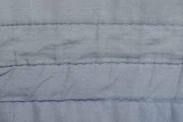 gray cloth background from old crumpled fabric with seams