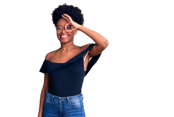 Young african american woman wearing casual clothes smiling happy doing ok sign with hand on eye looking through fingers