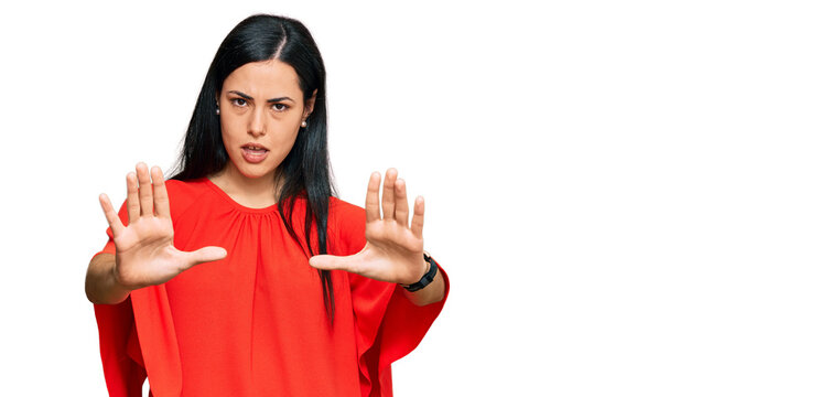 Beautiful young woman wearing casual clothes doing stop gesture with hands palms, angry and frustration expression
