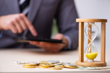 Young man earning money via Internet in time management concept
