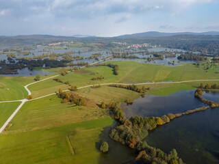 Fototapeta premium flooded valley green fields and trees forest