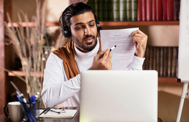 Teacher At Laptop Having Online Class With Remote Students Indoors
