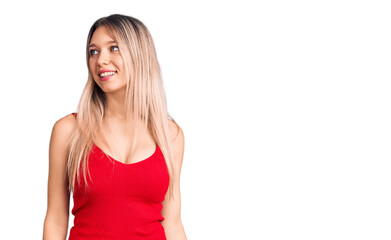 Fototapeta premium Young beautiful blonde woman wearing casual clothes looking away to side with smile on face, natural expression. laughing confident.