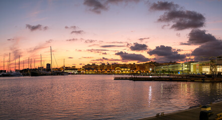 Fototapeta premium Sunset at the port of Valencia harbor, water reflection marina port nautical scene