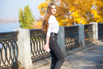 Close up portrait of a young beautiful woman in autumn park