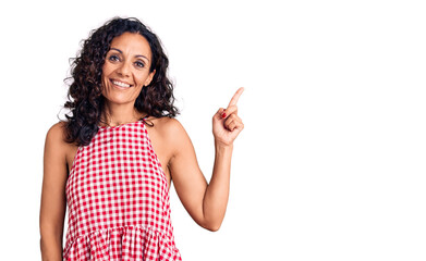 Middle age beautiful woman wearing casual sleeveless t shirt smiling happy pointing with hand and finger to the side