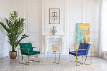 modern and very stylish interior design of large studio apartment with fashionable furniture with gold elements. very light and bright room with big windows