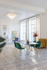 modern and very stylish interior design of large studio apartment with fashionable furniture with gold elements. very light and bright room with big windows