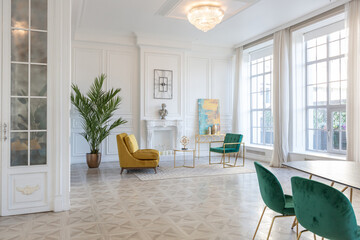 modern and very stylish interior design of large studio apartment with fashionable furniture with gold elements. very light and bright room with big windows