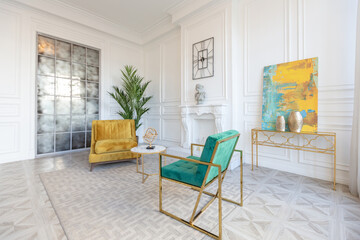 modern and very stylish interior design of large studio apartment with fashionable furniture with gold elements. very light and bright room with big windows