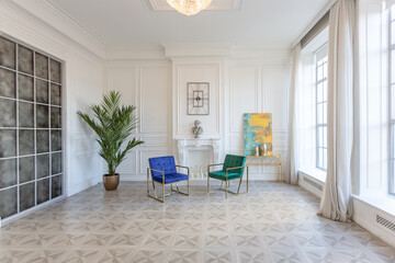 modern and very stylish interior design of large studio apartment with fashionable furniture with gold elements. very light and bright room with big windows