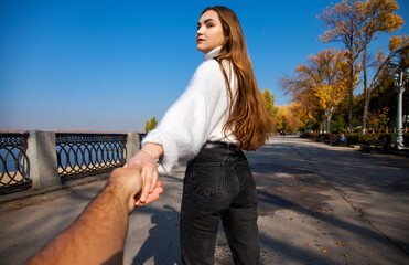 Follow me - young girl holds her boyfriends hand