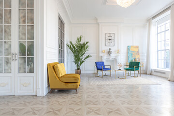 modern and very stylish interior design of large studio apartment with fashionable furniture with gold elements. very light and bright room with big windows