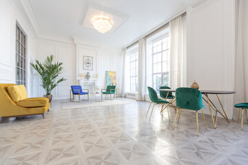 Fototapeta premium modern and very stylish interior design of large studio apartment with fashionable furniture with gold elements. very light and bright room with big windows