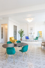 modern and very stylish interior design of large studio apartment with fashionable furniture with gold elements. very light and bright room with big windows