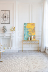 modern and very stylish interior design of large studio apartment with fashionable furniture with gold elements. very light and bright room with big windows
