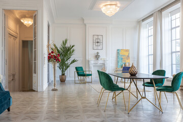 modern and very stylish interior design of large studio apartment with fashionable furniture with gold elements. very light and bright room with big windows