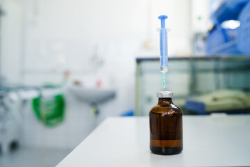 Close up on syringe with needle and injection on the table at hospital or laboratory medicine ready to use - covid-19 coronavirus vaccine research concept copy space