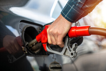 Car refueling on the petrol station. Male hand filling gasoline to the car. Pumping gasoline fuel in car at gas station,travel,transportation and holiday