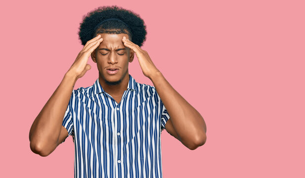 African american man with afro hair wearing casual clothes suffering from headache desperate and stressed because pain and migraine. hands on head.