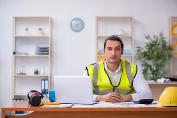 Young male architect working in the office