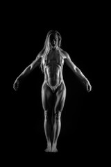 Fototapeta na wymiar muscular female against black background 