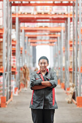 Young successful female worker of warehouse in workwear crossing arms by chest