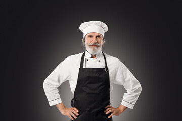 Mature male chef on dark background