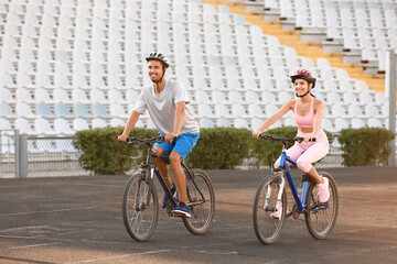 Sporty young couple riding bicycles at the stadium © Pixel-Shot