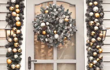 House christmas decorations in gold and silver colors. Сhristmas wreath on the door 