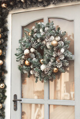 House christmas decorations in gold and silver colors. Сhristmas wreath on the door 