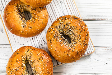 Freshly Baked Bagels Topped with Sesame Seeds, Poppyseeds, Garlic and Onion. Selective focus.