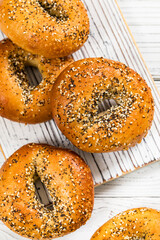 Freshly Baked Bagels Topped with Sesame Seeds, Poppyseeds, Garlic and Onion. Selective focus.