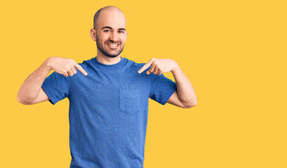 Young handsome man wearing casual t shirt looking confident with smile on face, pointing oneself with fingers proud and happy.