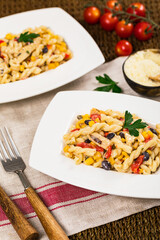 Cheesy Grilled Chicken Alfredo Pasta Florentine with Black Beans and Corn. Selective focus.