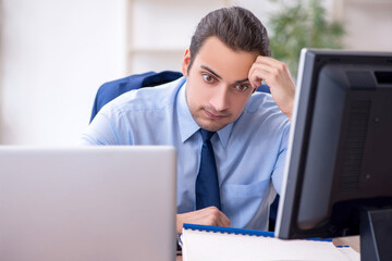 Young male employee unhappy with excessive work