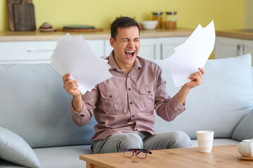 Stressed young man at home
