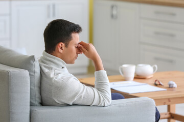 Stressed young man at home