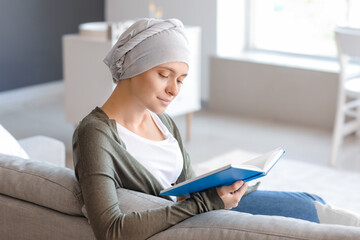 Woman after chemotherapy reading book at home